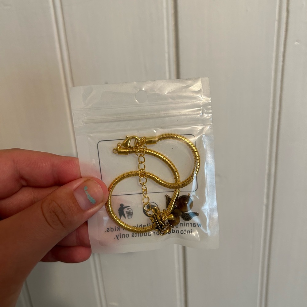 NEW small shop gold looking with purple angel charm bracelet